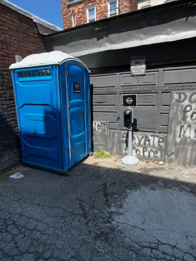 Porta potty placed behind a business